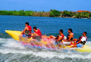 Guests riding a banana boat on a lagoon