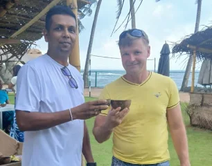 Our host toasting with a guest by the beach