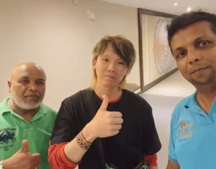 A guest giving a thumbs up in a selfie with our team